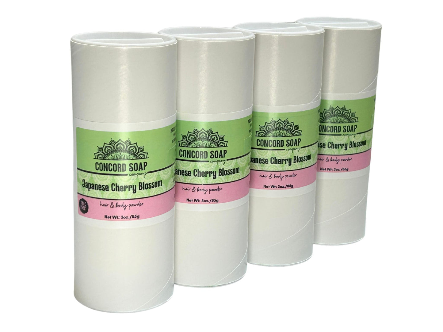 Four eco-friendly white cardboard shakers of handmade Japanese Cherry Blossom hair and body powder by Concord Soap Company, displayed on a solid white background. Each container has a green and white label featuring the company logo and product name. The tubes are arranged side by side in a row, showcasing the product packaging and branding. Natural talc-free powder in the popular Japanese cherry blossom fragrance for a sweet, powdery, floral scented skincare and personal hygiene product.