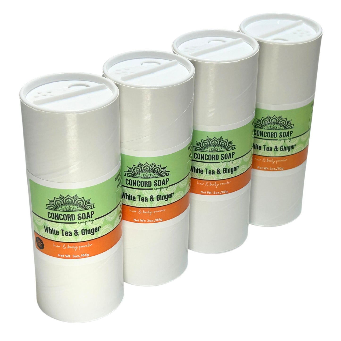 Four eco-friendly white cardboard shakers of handmade White Tea and Ginger hair and body powder by Concord Soap Company, displayed on a solid white background. Each container has a green and white label featuring the company logo and product name. The tubes are arranged side by side in a row, showcasing the product packaging and branding. Natural talc-free powder in the popular white tea and ginger fragrance for a ginger and citrus scented skincare and personal hygiene product.