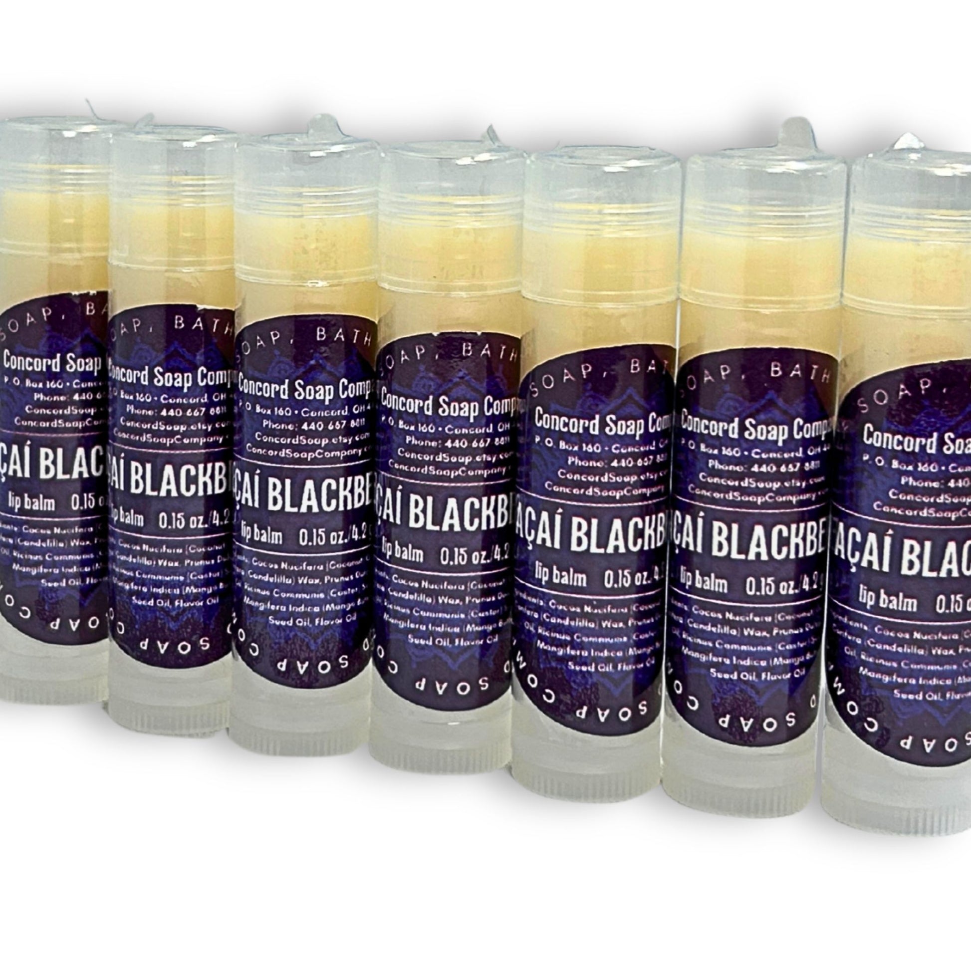 Handmade Açaí Blackberry lip balm tubes angled in a slight diagonal line. Each of these natural lip balms by Concord Soap Company has a deep purple circle label with product and company details and is shrink wrapped for safety. Listing is for ONE lip balm.