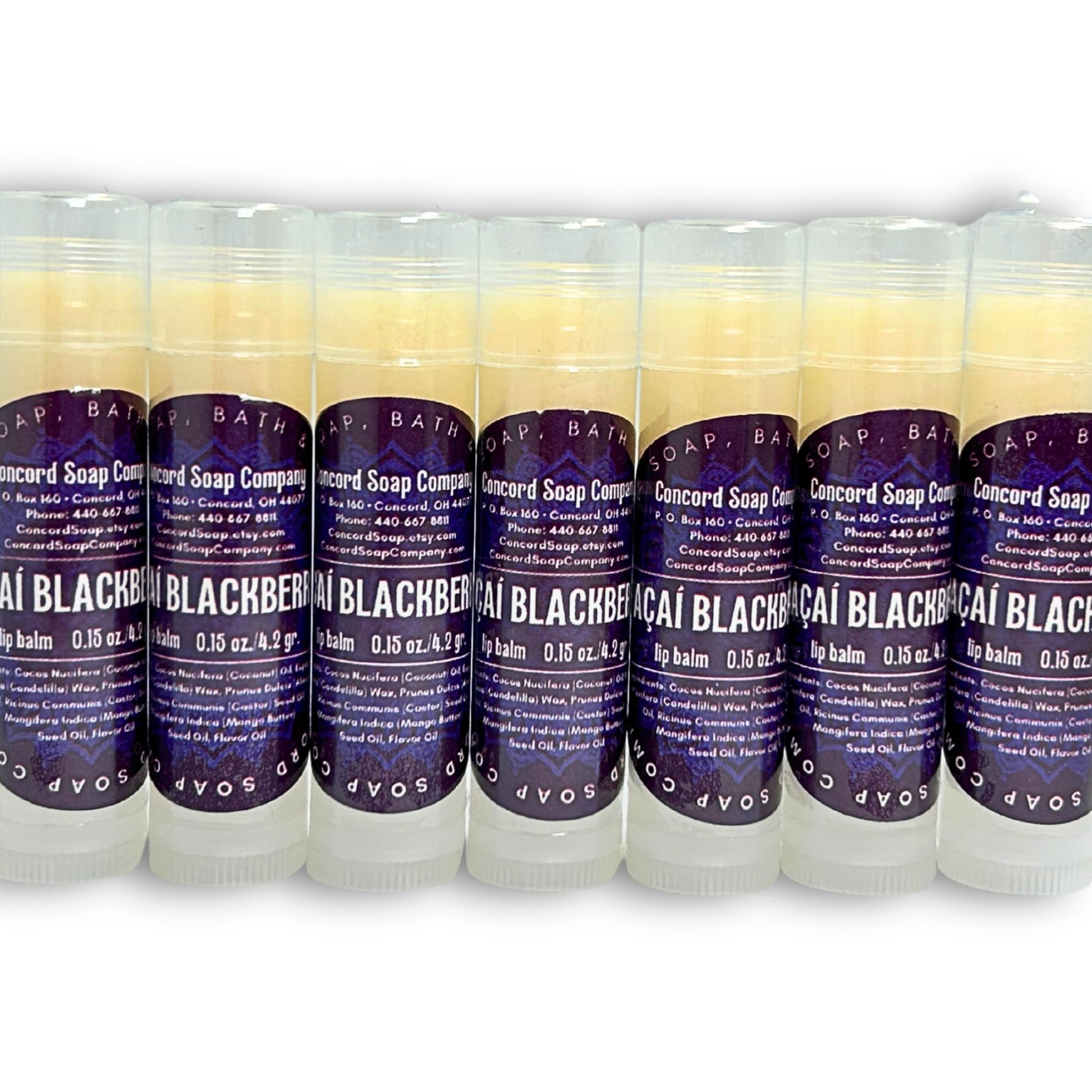 Row of several Açaí Blackberry lip balms, natural handmade skincare by Concord Soap Company. Each lip balm has a deep purple circle label and is shrink wrapped for safety. Listing is for ONE lip balm.