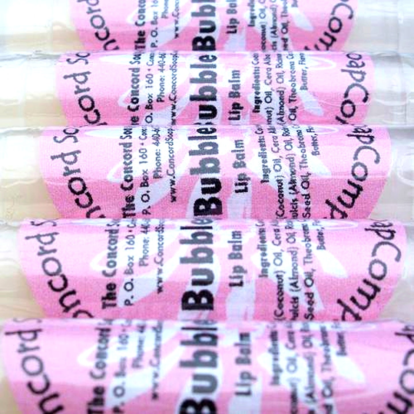 Handmade Bubble Gum lip balm tubes with pink labels displayed in a row on a white background.