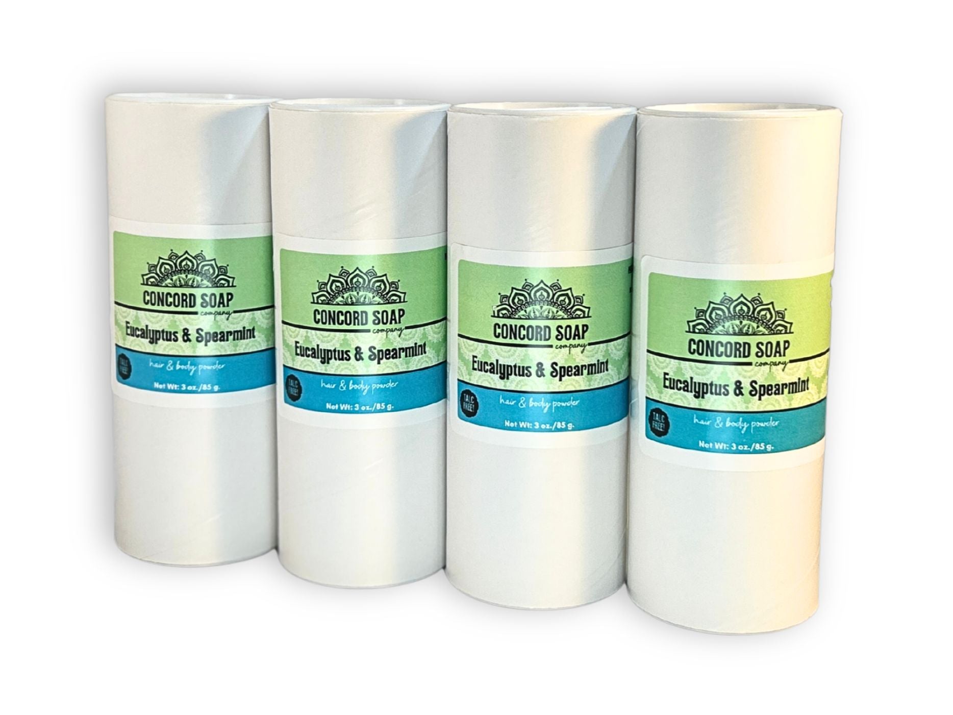 Four eco-friendly white cardboard shakers of handmade Eucalyptus and Spearmint hair and body powder by Concord Soap Company, displayed on a solid white background. Each container has a green and white label featuring the company logo and product name. The tubes are arranged side by side in a row, showcasing the product packaging and branding. Natural talc-free powder in a very popular unisex fragrance for a fresh, minty scented skincare and personal hygiene product.