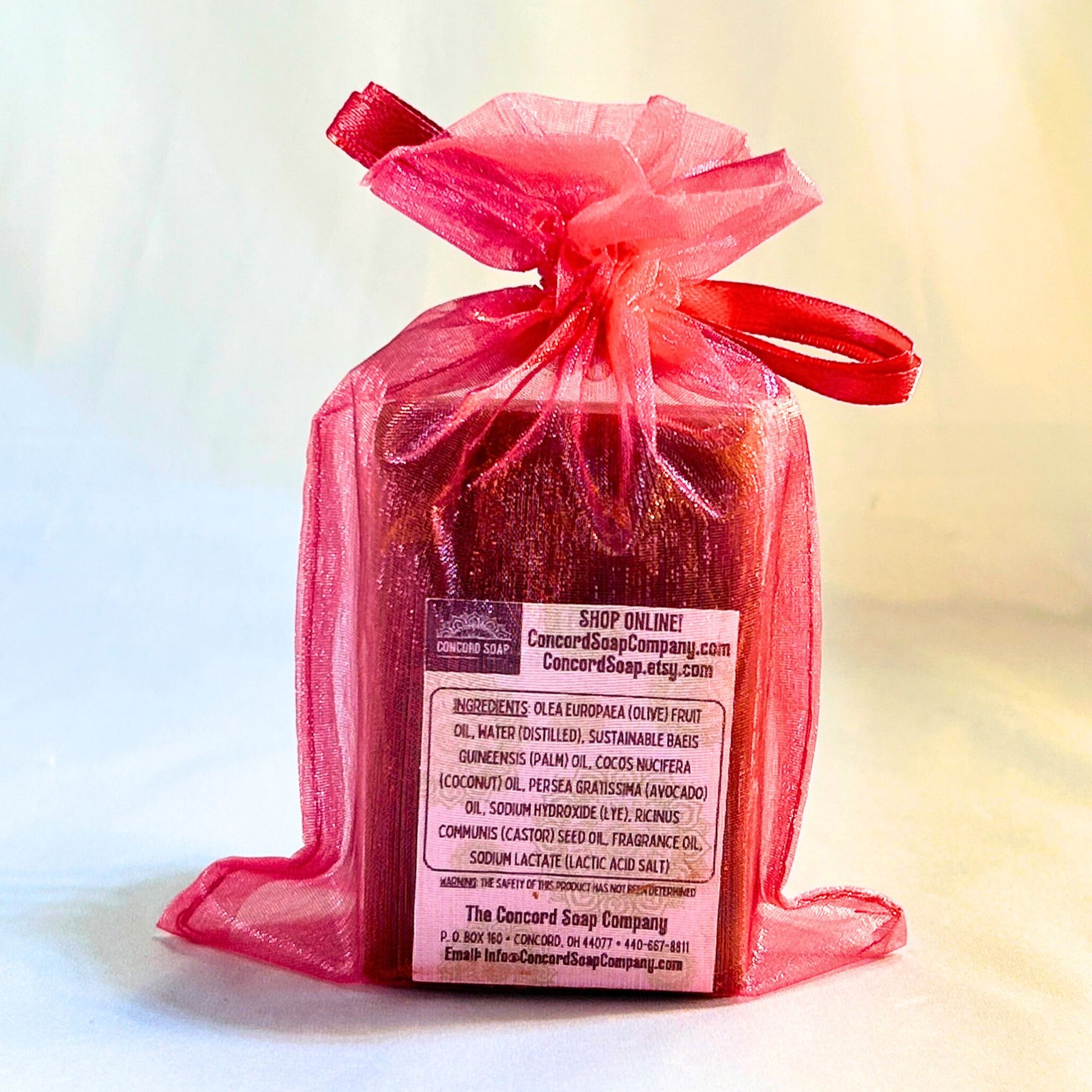 Single Tropical Smoothie soap bar in a bright pink organza bag, back view showing the full ingredients label.