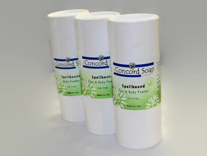 Three eco-friendly white cardboard shakers of handmade Spellbound hair and body powder by Concord Soap Company, displayed on a solid white background. Each container has a green and white label. Natural talc-free powder in a LoveSpell dupe fragrance for a fresh, citrusy floral scented skincare and personal hygiene.