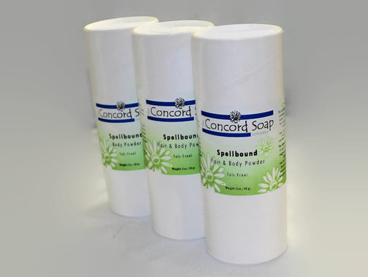 Three eco-friendly white cardboard shakers of handmade Spellbound hair and body powder by Concord Soap Company, displayed on a solid white background. Each container has a green and white label. Natural talc-free powder in a LoveSpell dupe fragrance for a fresh, citrusy floral scented skincare and personal hygiene.