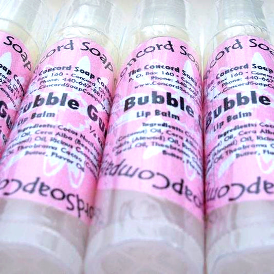 Close-up of Bubble Gum scented lip balm tubes with pink labels, arranged together on a clean white backdrop.