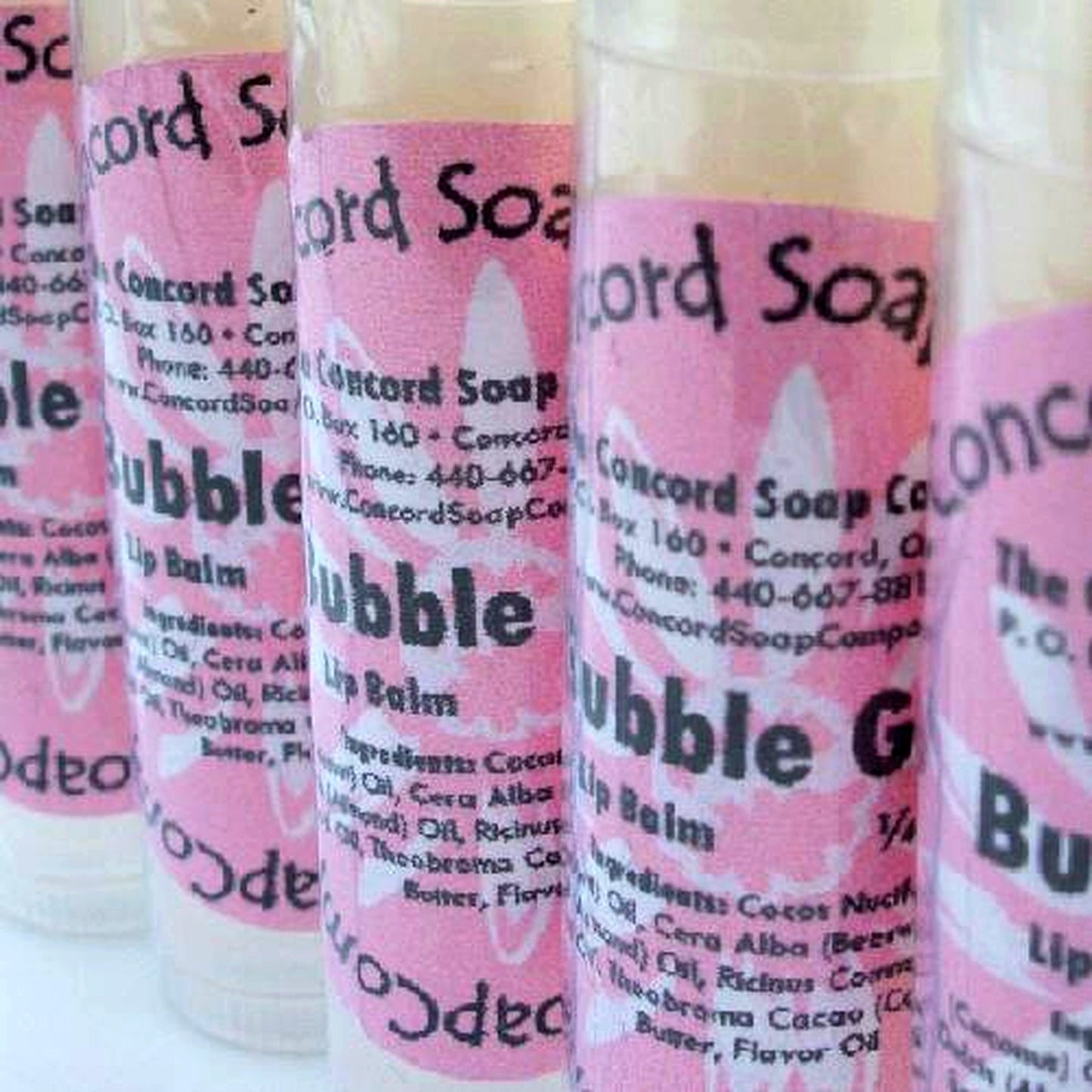 Handmade Bubble Gum lip balm tubes with pink labels displayed in a row on a white background.