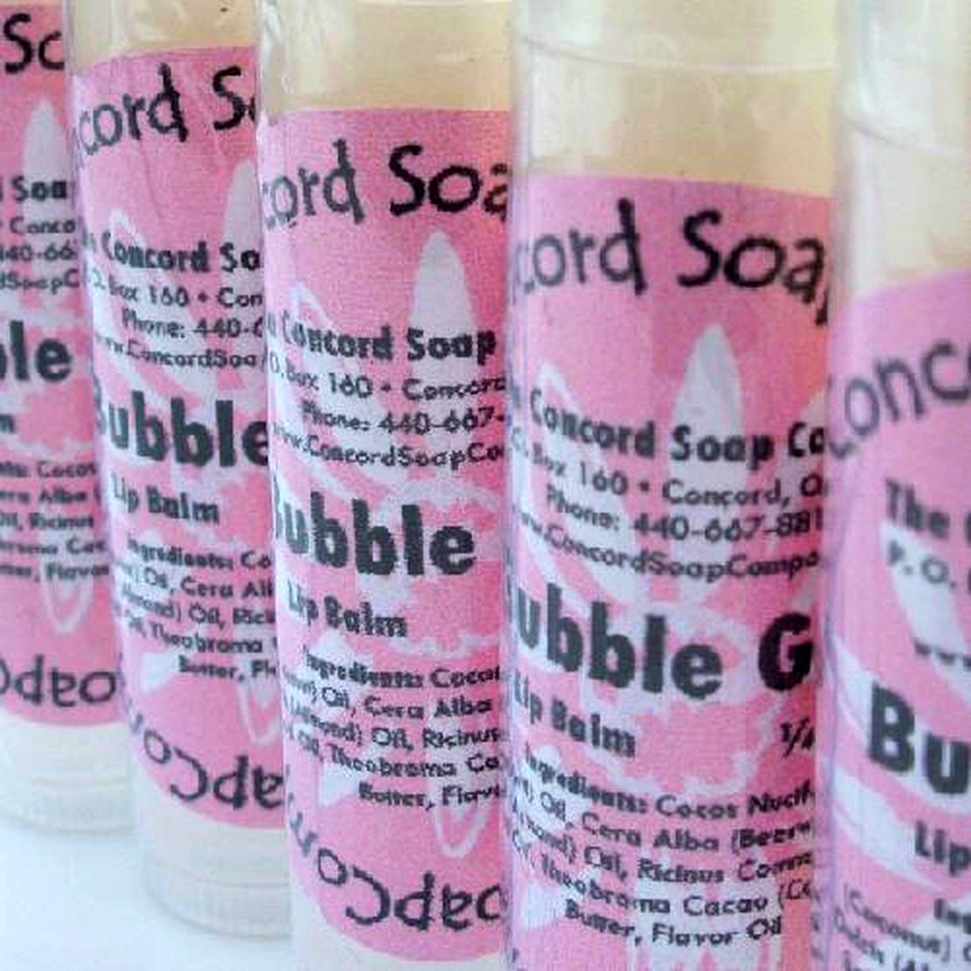 Handmade Bubble Gum lip balm tubes with pink labels displayed in a row on a white background.