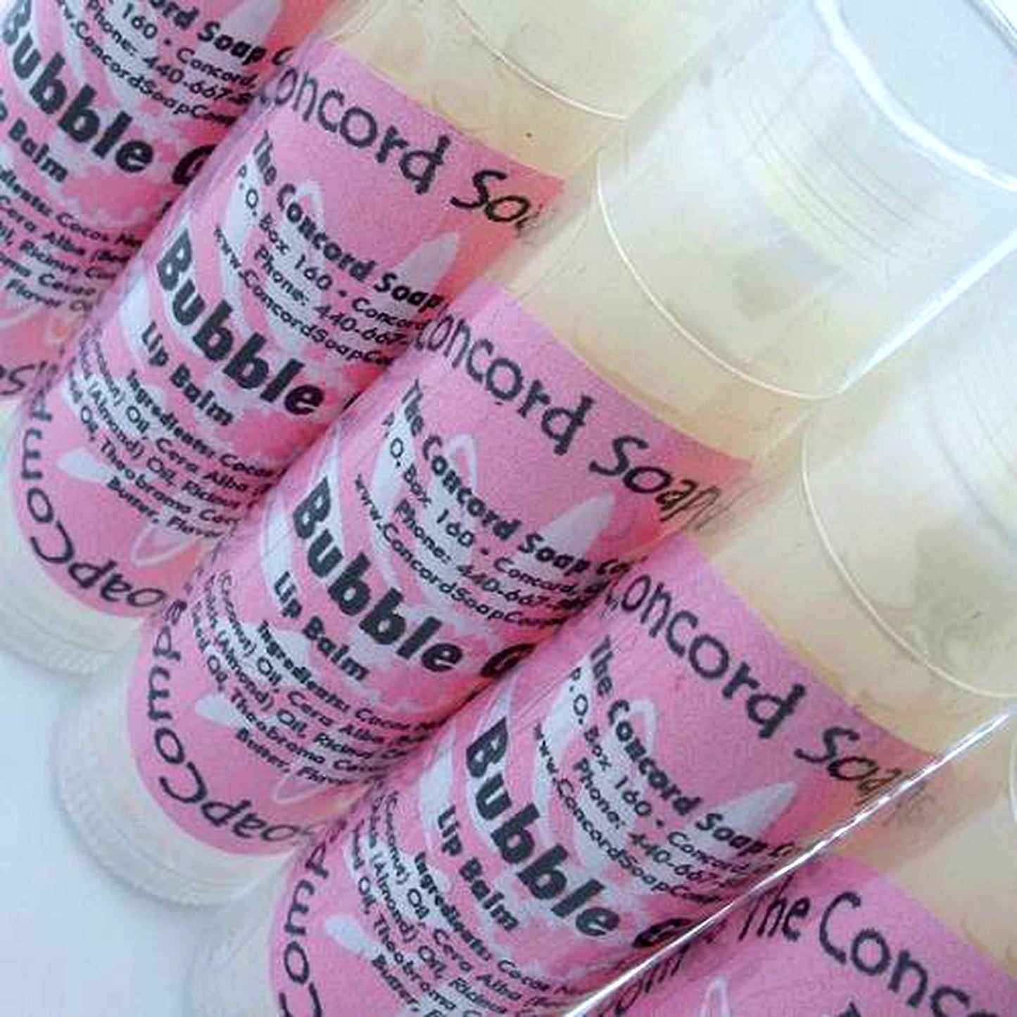 Bubble Gum flavored lip balm tubes arranged on a bright white background with soft shadows.
