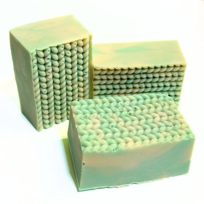 Three Cashmere Bliss soap bars unwrapped, showing the textured top design.