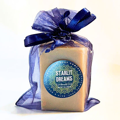 Single Starlit Dreams vegan handmade soap bar in a navy organza gift bag with satin ribbon and product label featuring a mandala.
