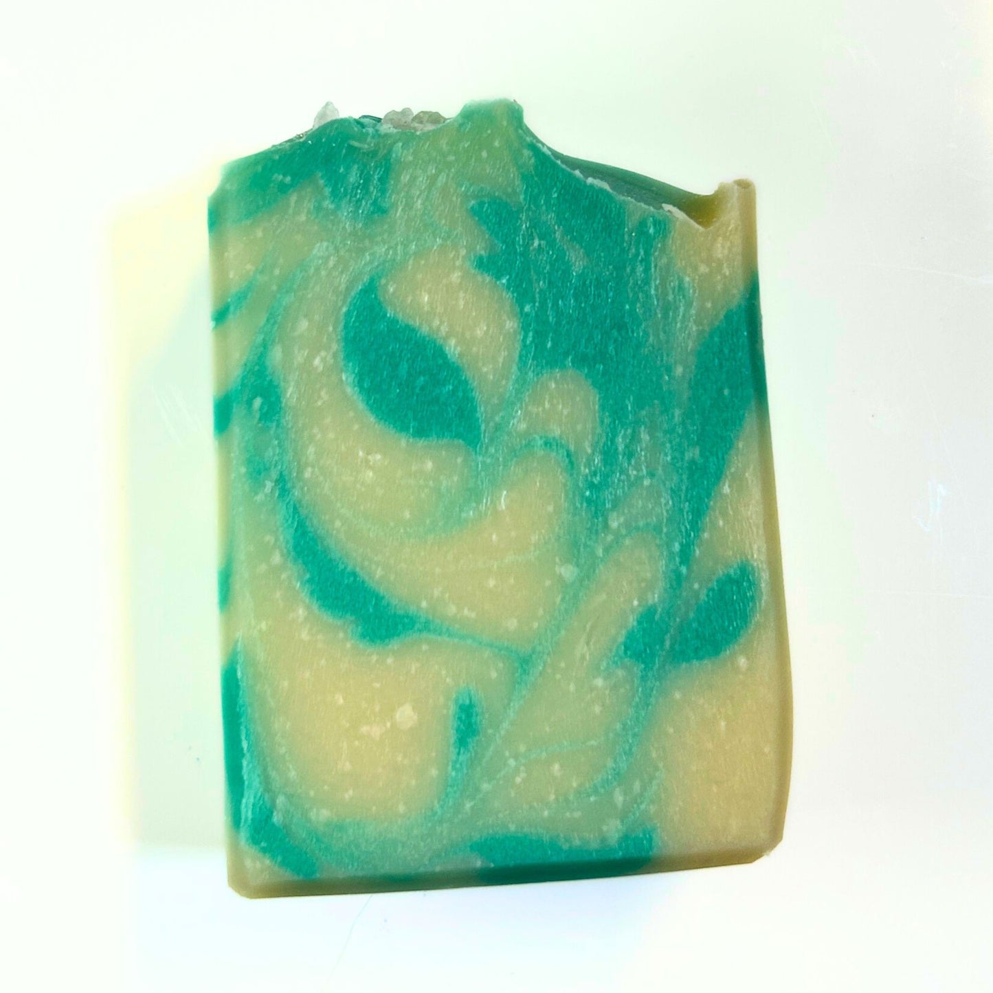 Flat lay front view of the Comfort & Joy soap bar highlighting the teal and cream swirl pattern.