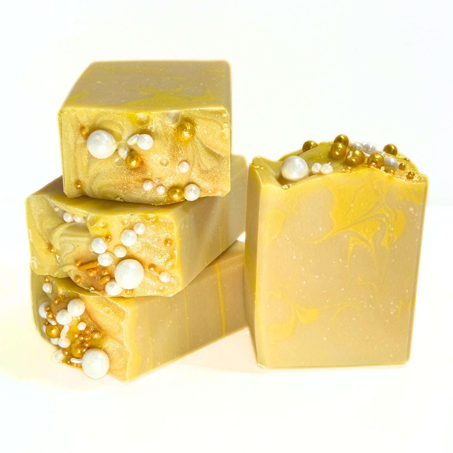 Three Apple Honey Champagne soap bars stacked next to another upright bar, decorated with gold and pearl soap embeds.