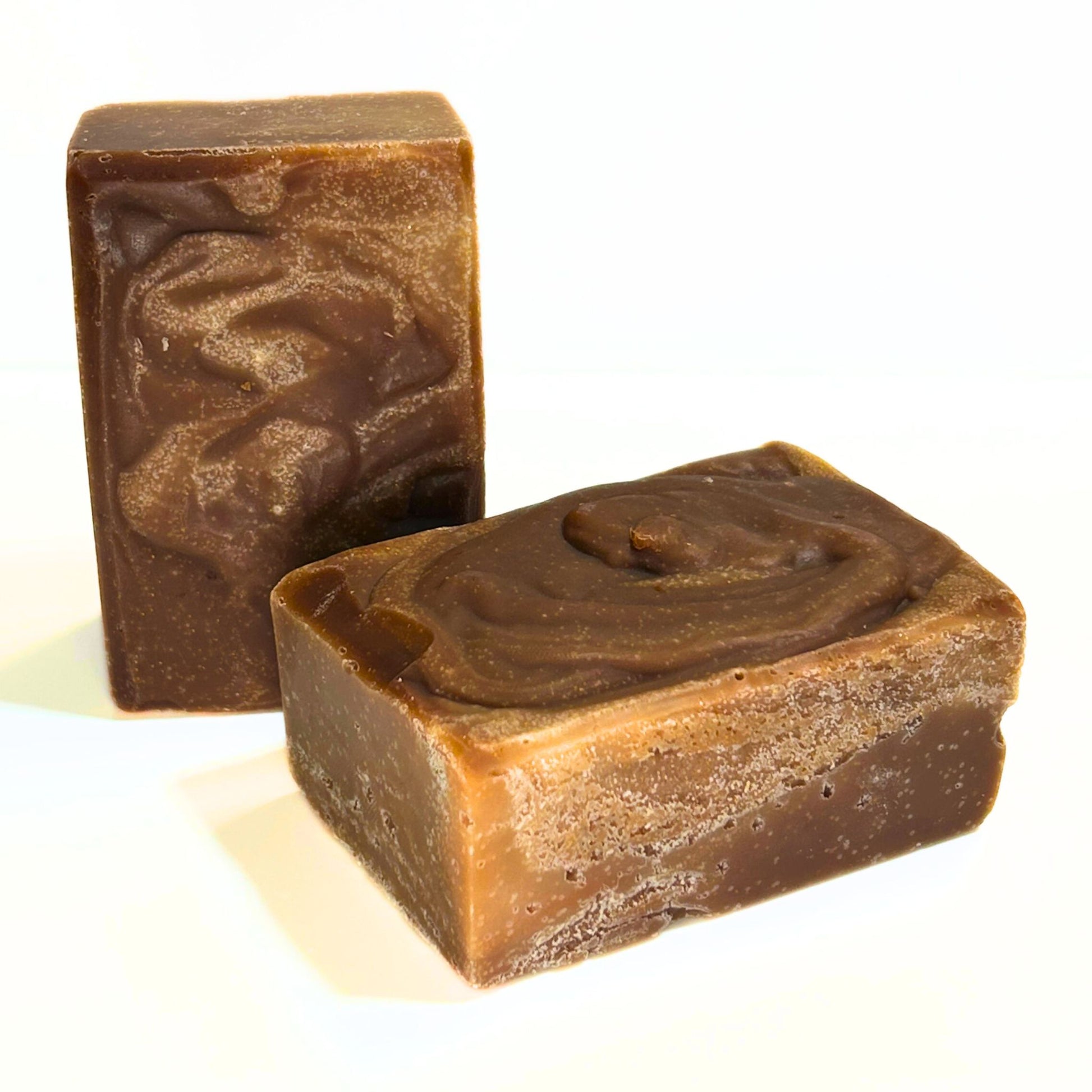 Two unwrapped Autumn Spice soap bars showing rich brown swirl pattern.
