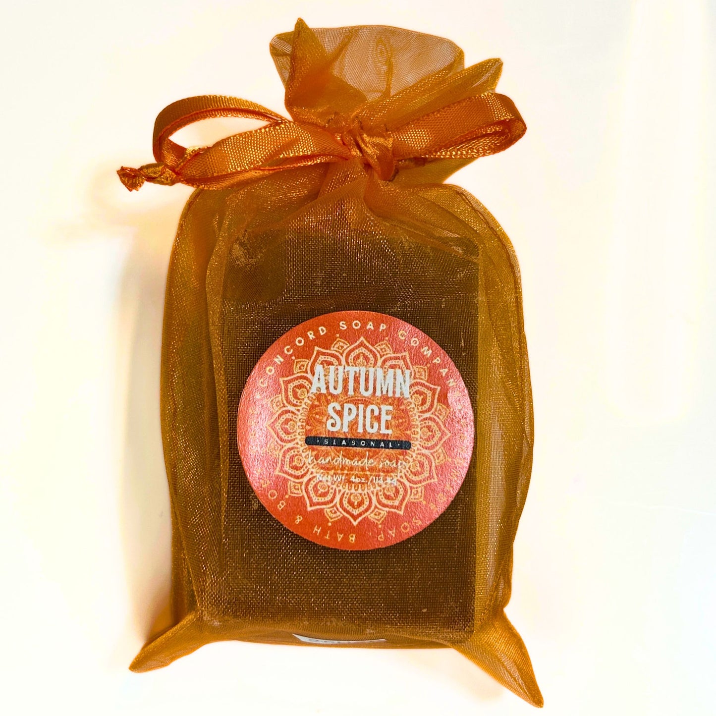 Autumn Spice soap wrapped in orange organza bag with front label.