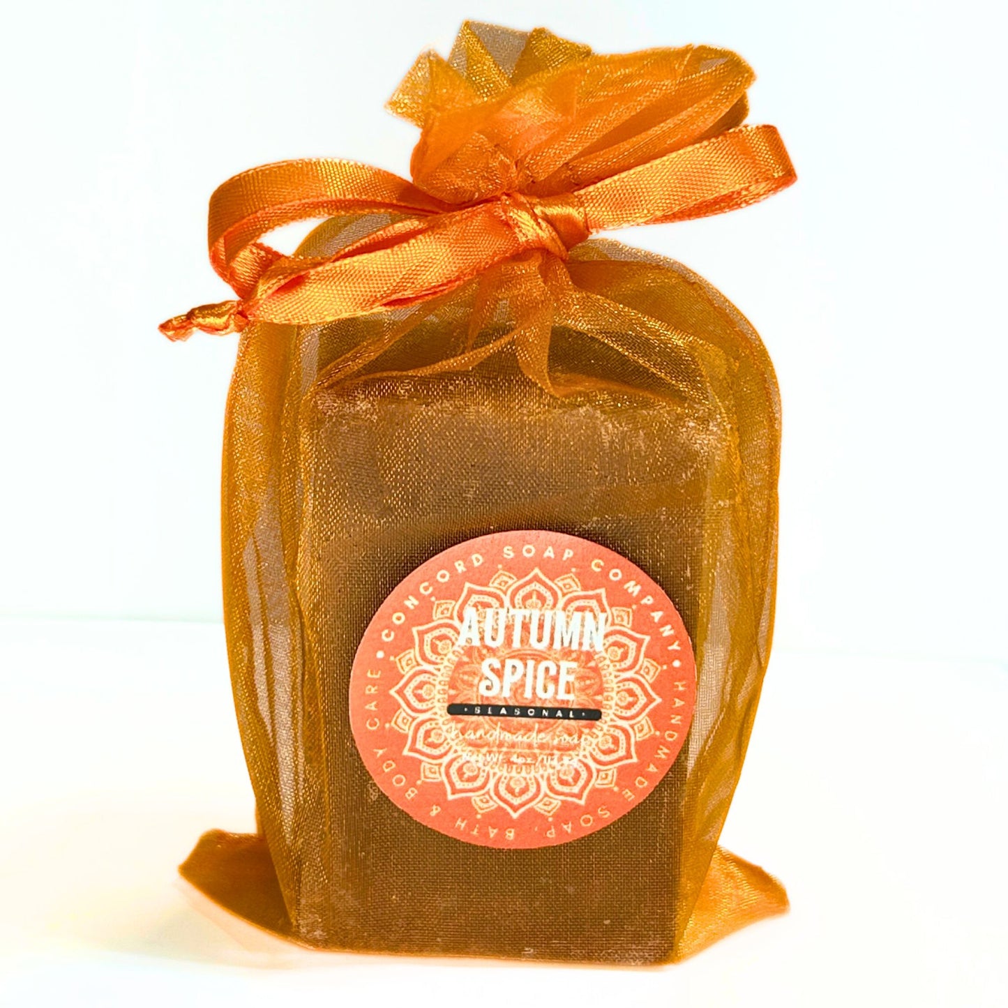 Single Autumn Spice soap in an orange organza bag shown from the front.
