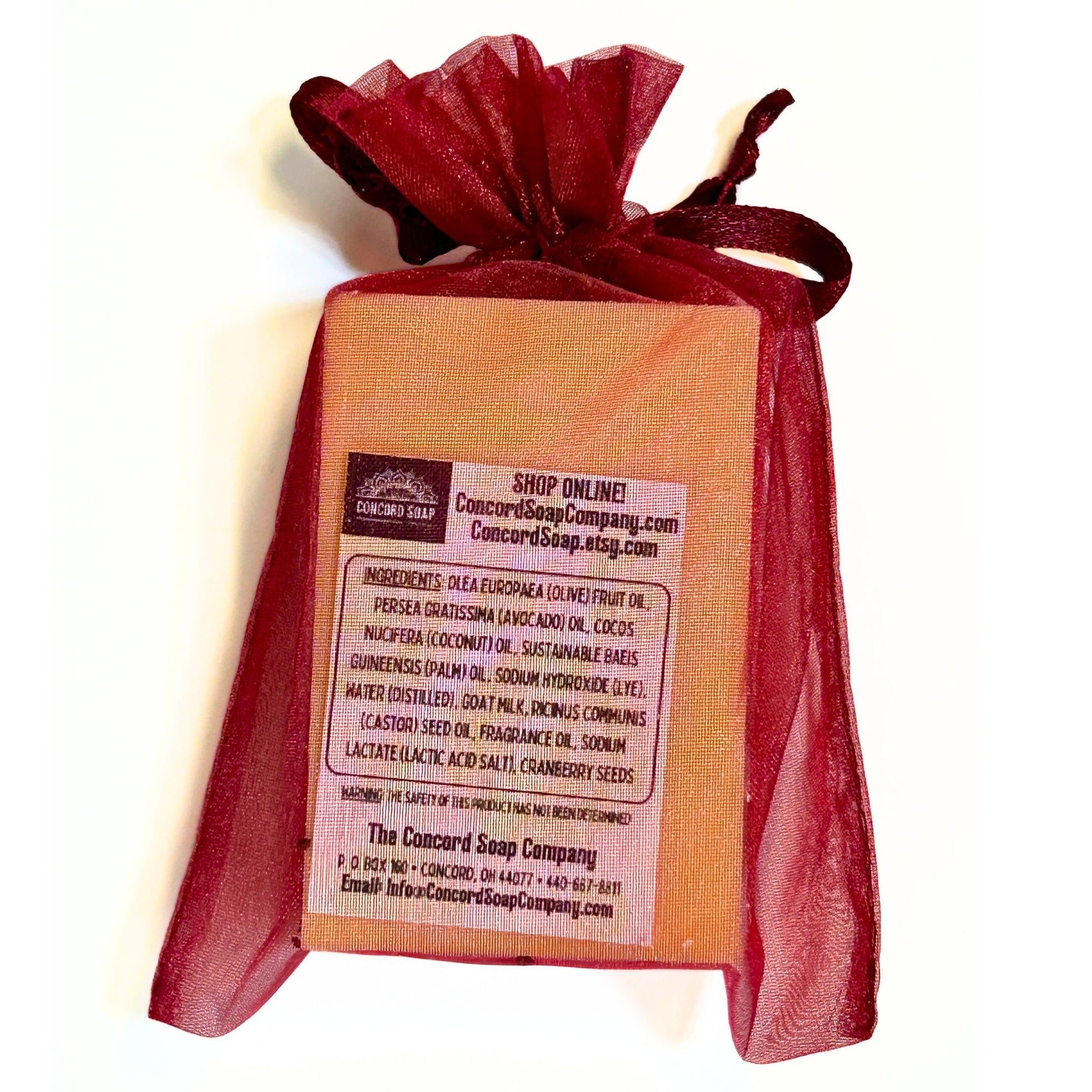 Back view of Cranberry soap in burgundy organza bag showing ingredient label.