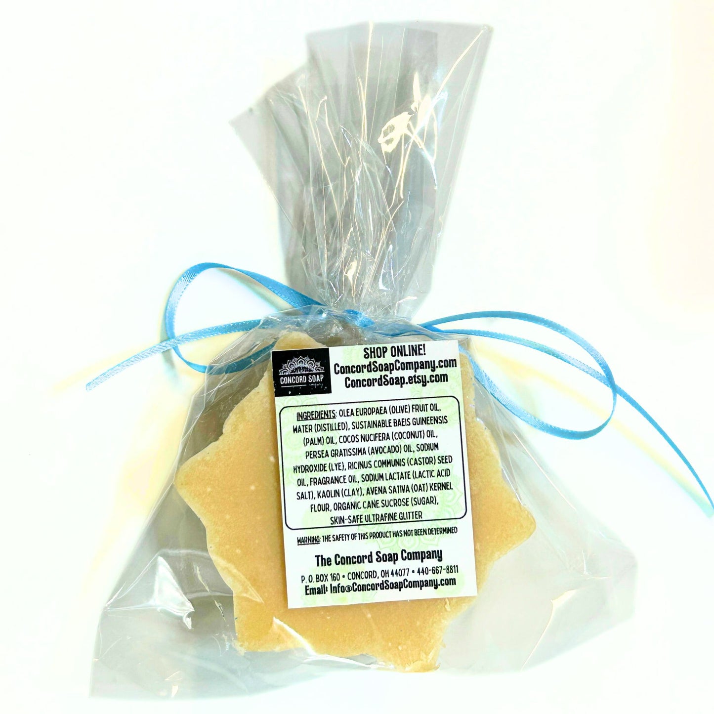 Back view of a wrapped Snowflake soap bar showing the ingredient label and shop information.