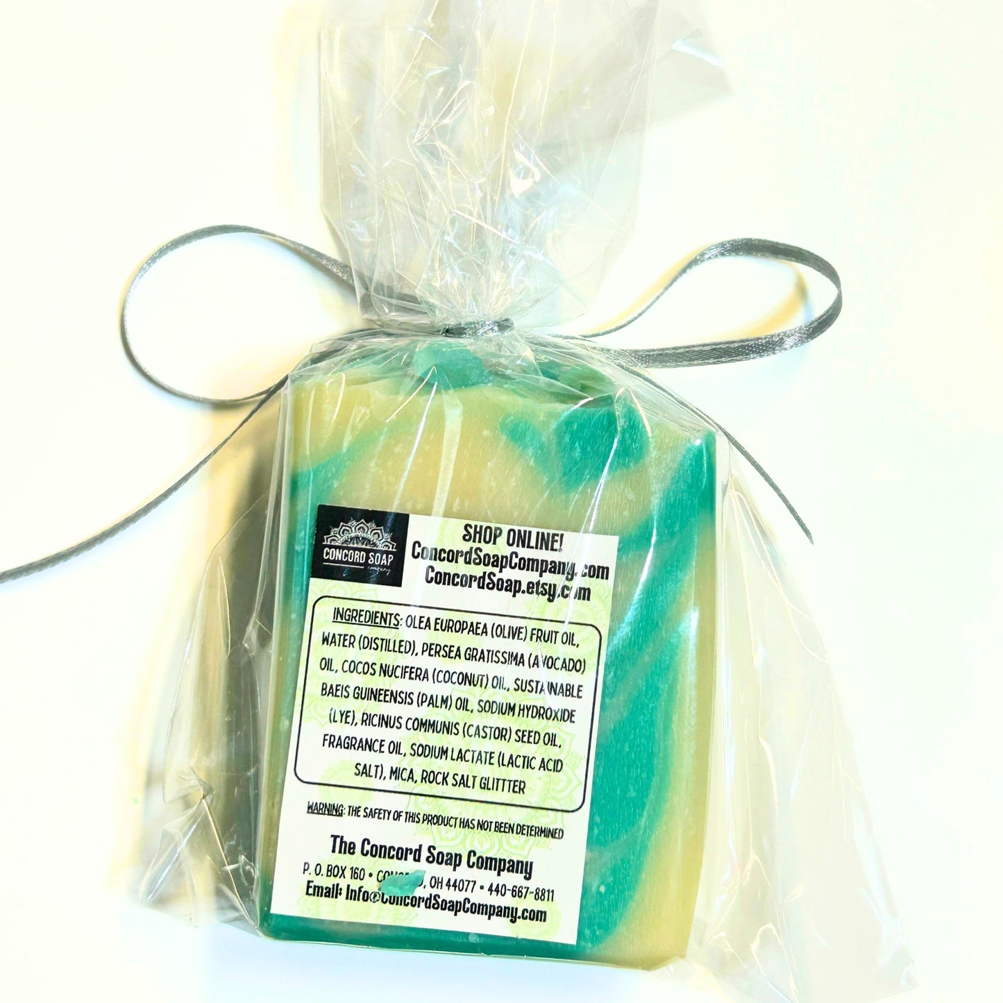 Flat lay view of the back of a wrapped Comfort & Joy soap bar showing the ingredient label and shop information.
