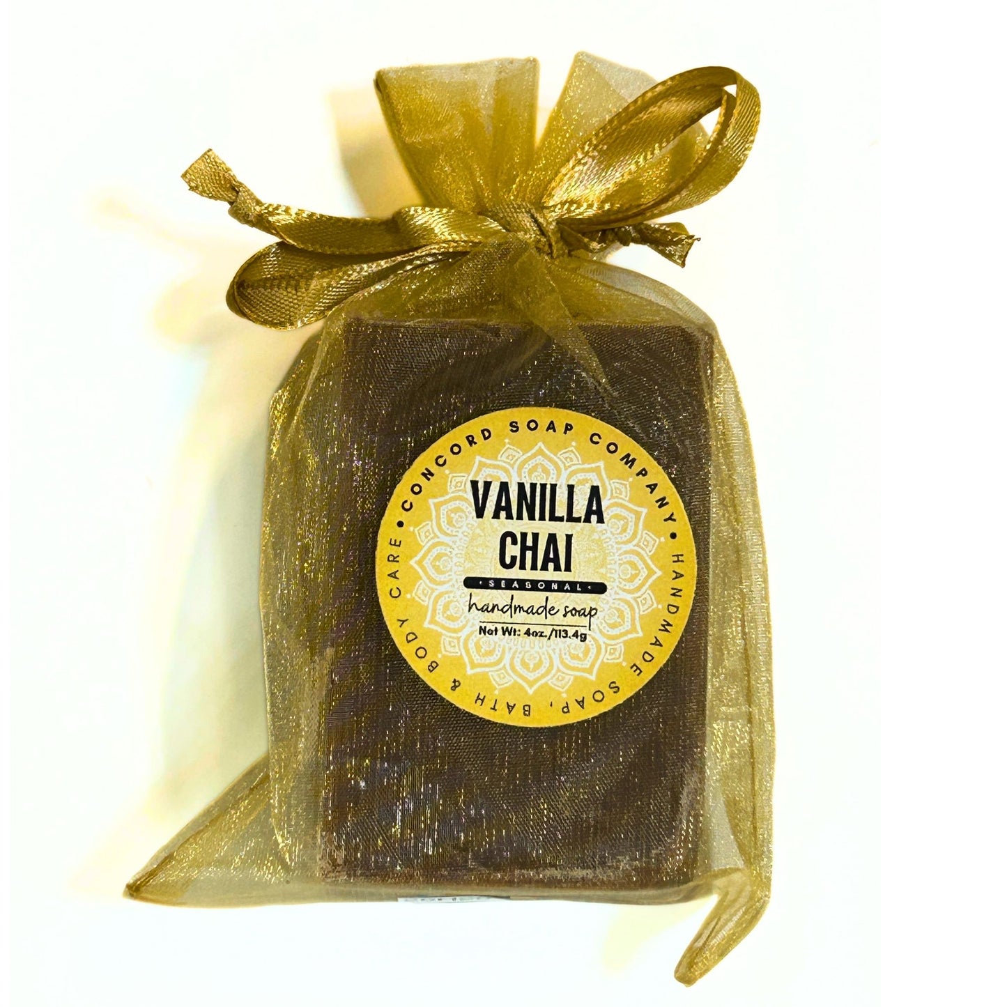 Flat lay view of the front of a single Vanilla Chai soap bar wrapped in a gold organza bag.