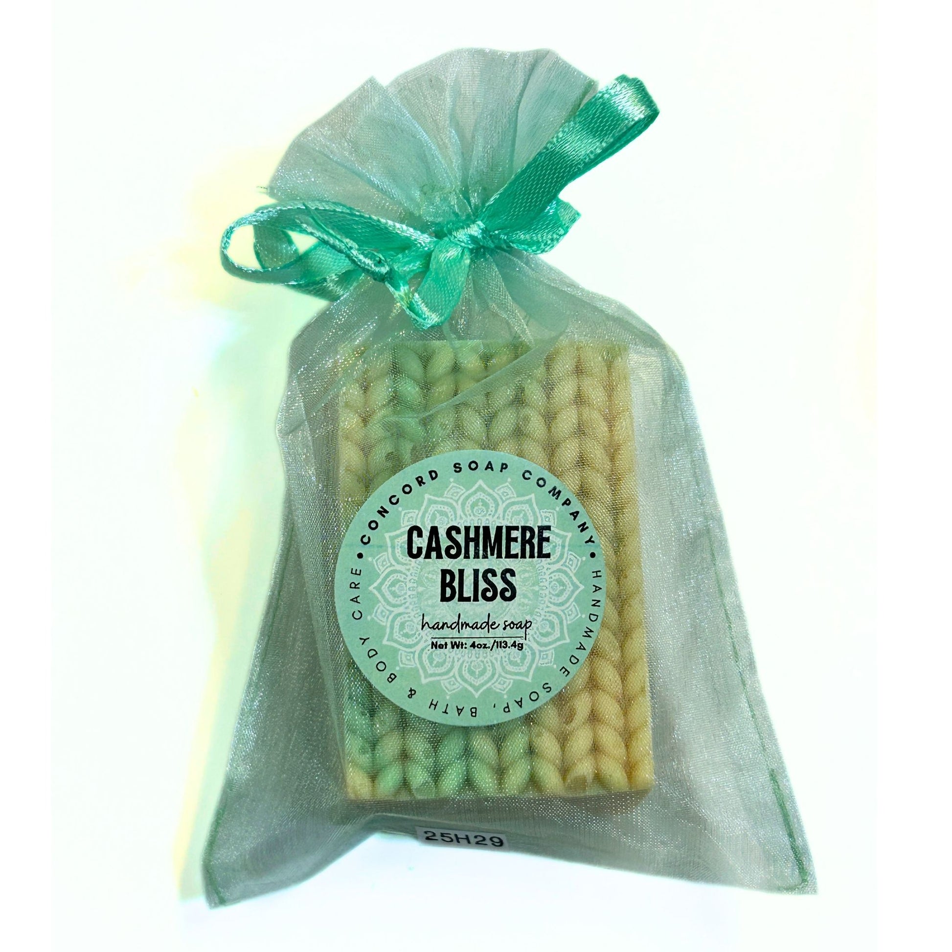 Flat lay angle of Cashmere Bliss soap in a mint green organza bag.
