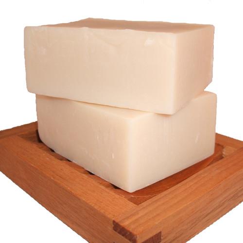 stack of two handmade soap bars on wooden soap dish