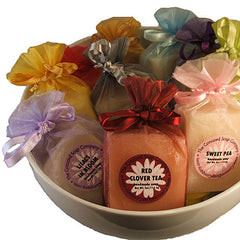 bowl of assorted handmade soap in assorted color organza bags